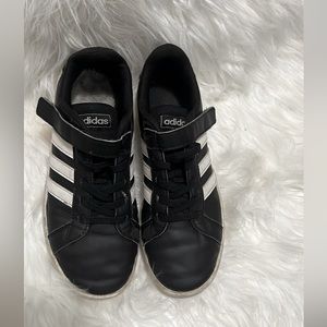 Worn out women’s Adidas Grand Court white and black sneakers